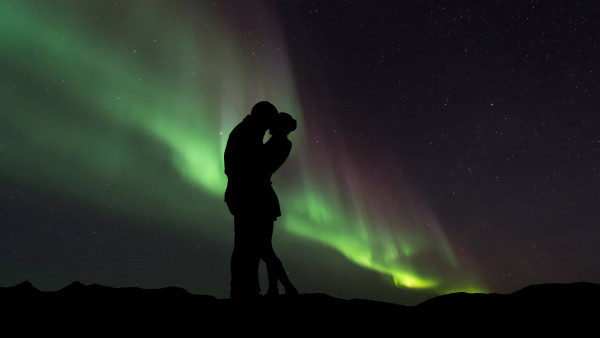 Couple in love under the Northern Lights