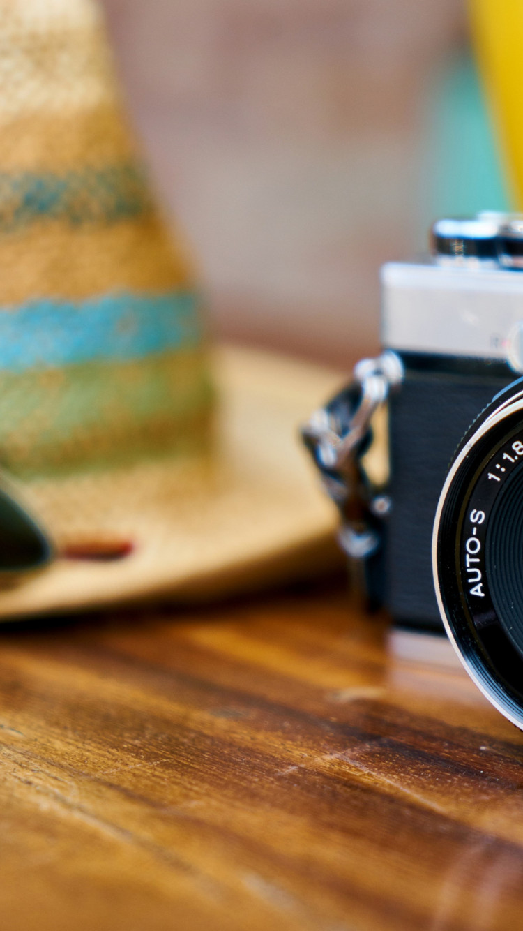 Old photo camera, hat and sunglasses wallpaper 750x1334