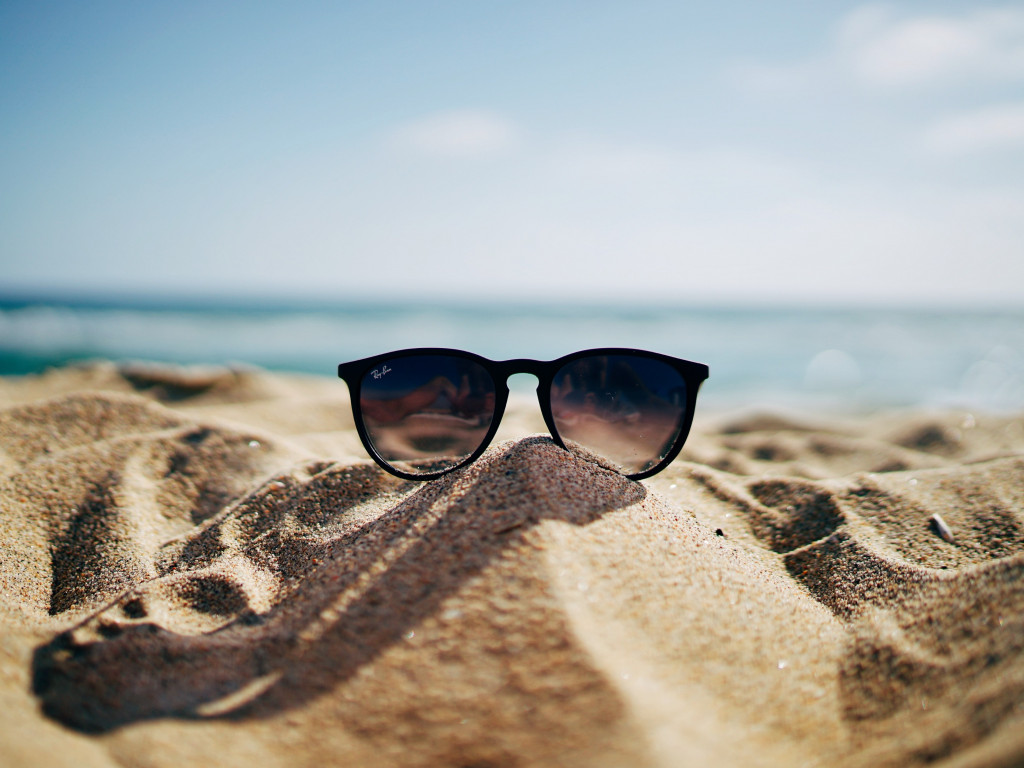 Ray Ban sunglasses on hot sand beach wallpaper 1024x768
