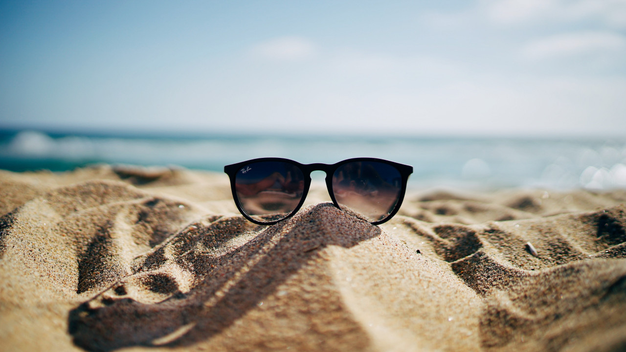 Ray Ban sunglasses on hot sand beach wallpaper 1280x720