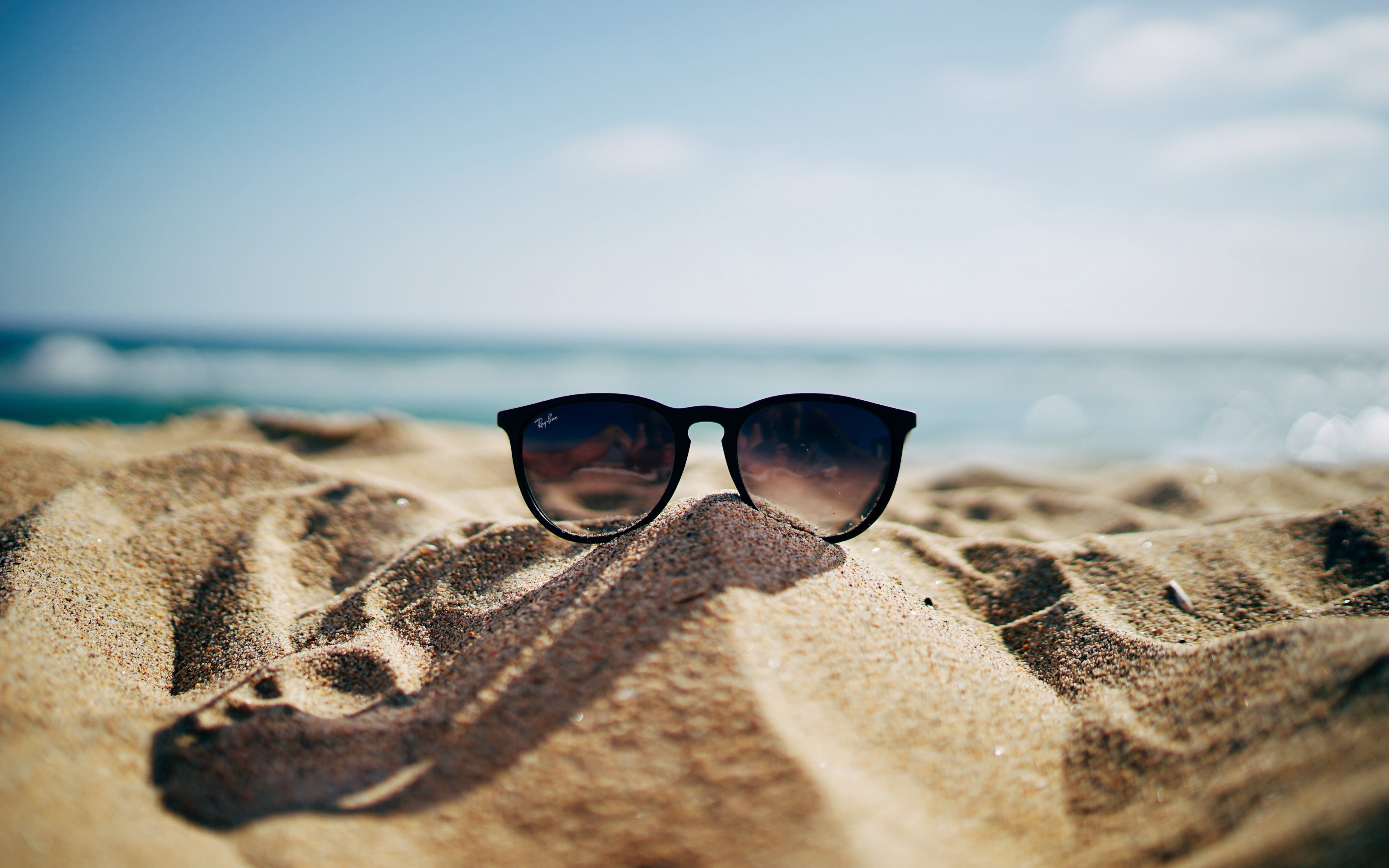 Ray Ban sunglasses on hot sand beach wallpaper 3840x2400