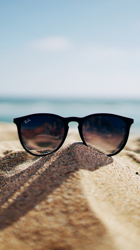 Ray Ban sunglasses on hot sand beach wallpaper 480x854