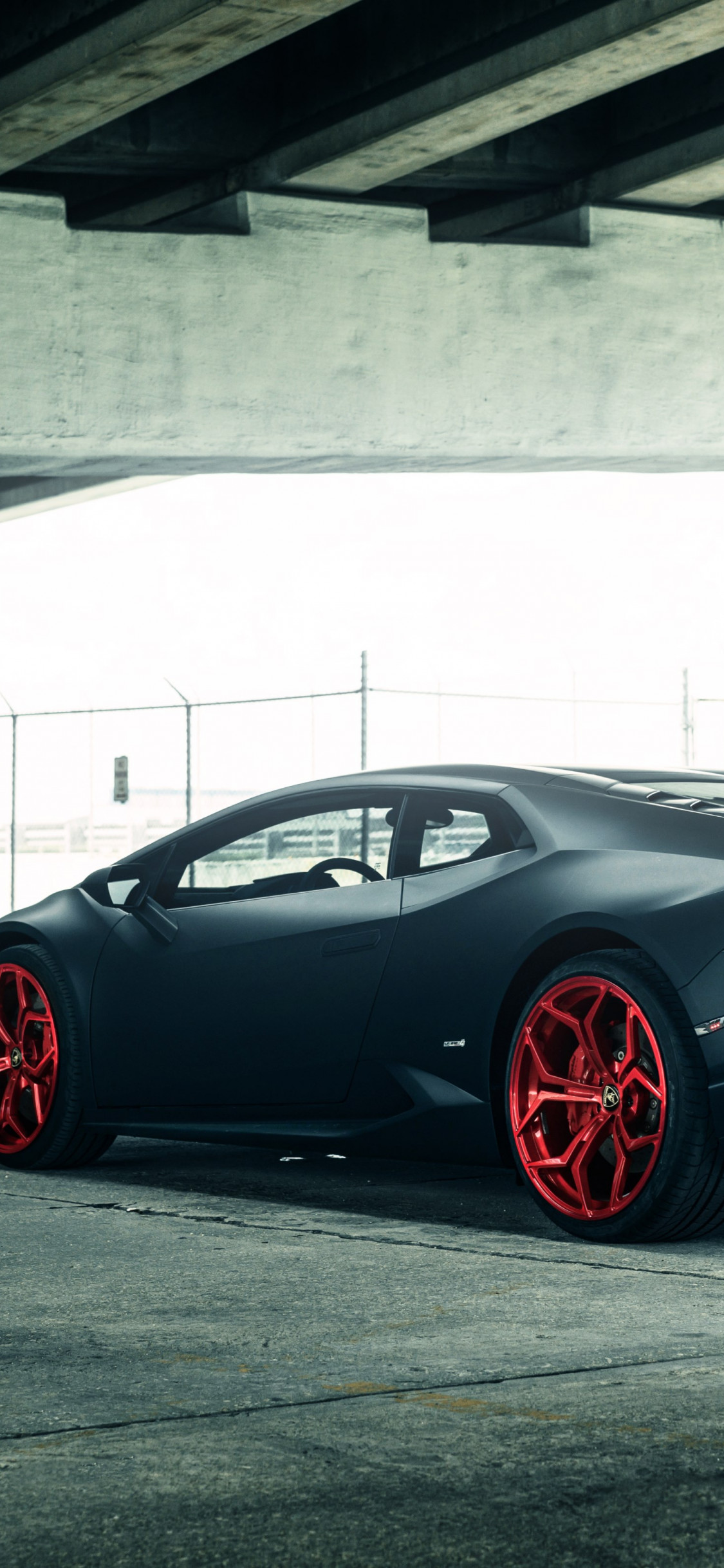 Vellano Matte Black Lamborghini Huracan on Red 3 wallpaper 1125x2436