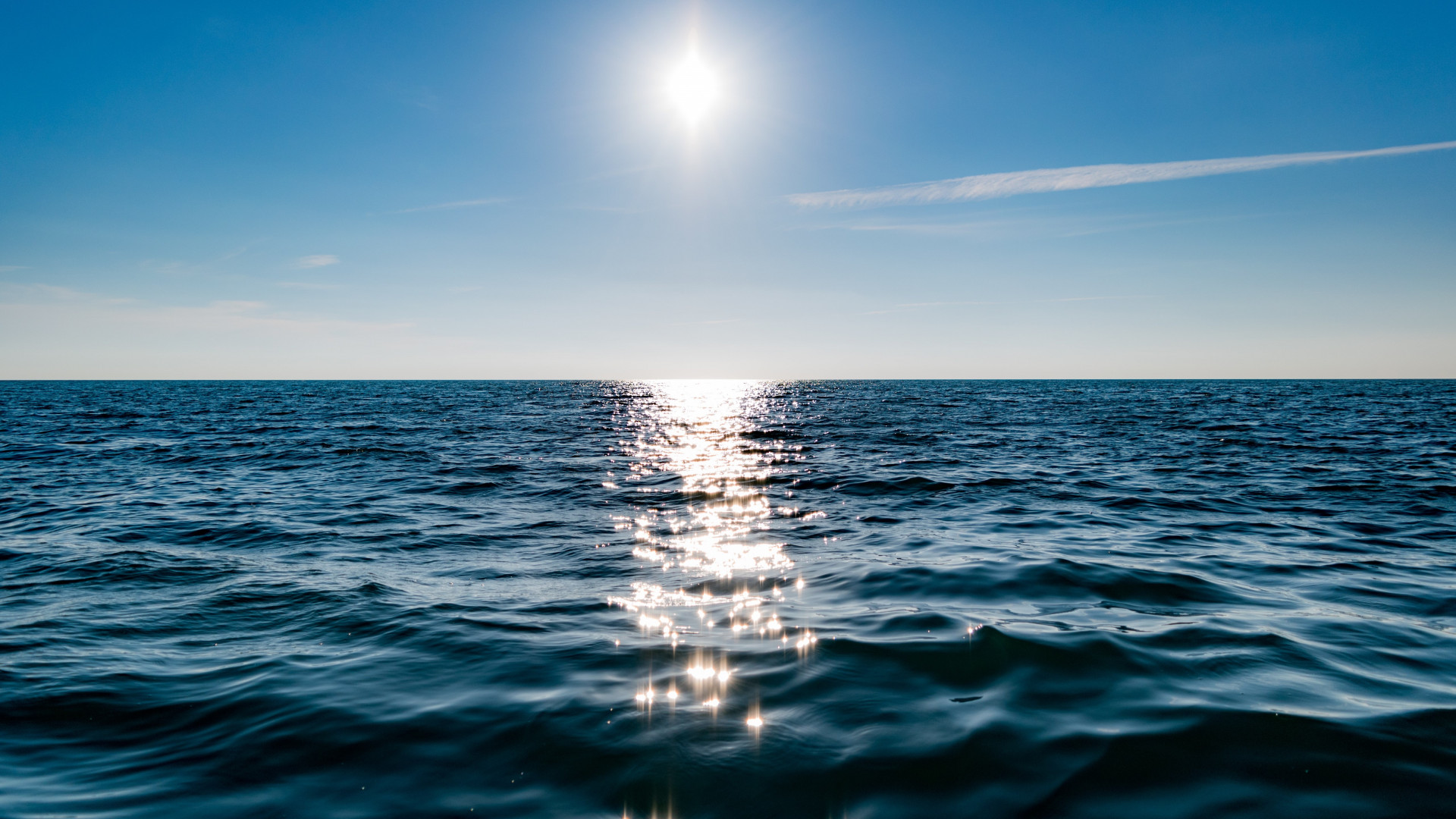 Sun on blue sky is reflected on water wallpaper 1920x1080
