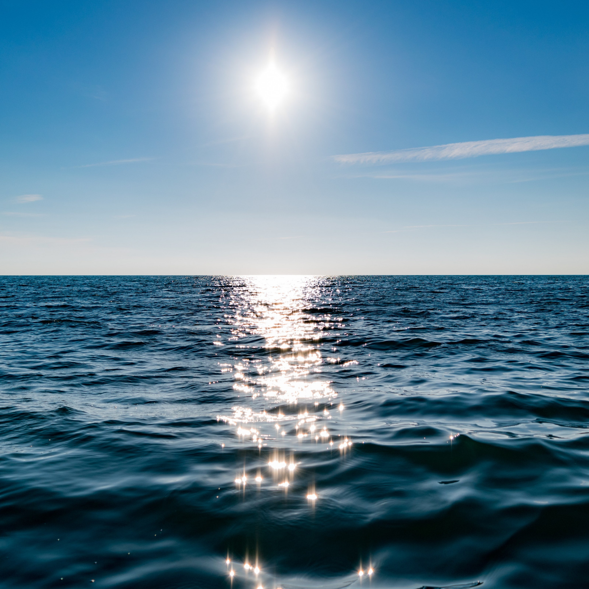 Sun on blue sky is reflected on water wallpaper 2048x2048