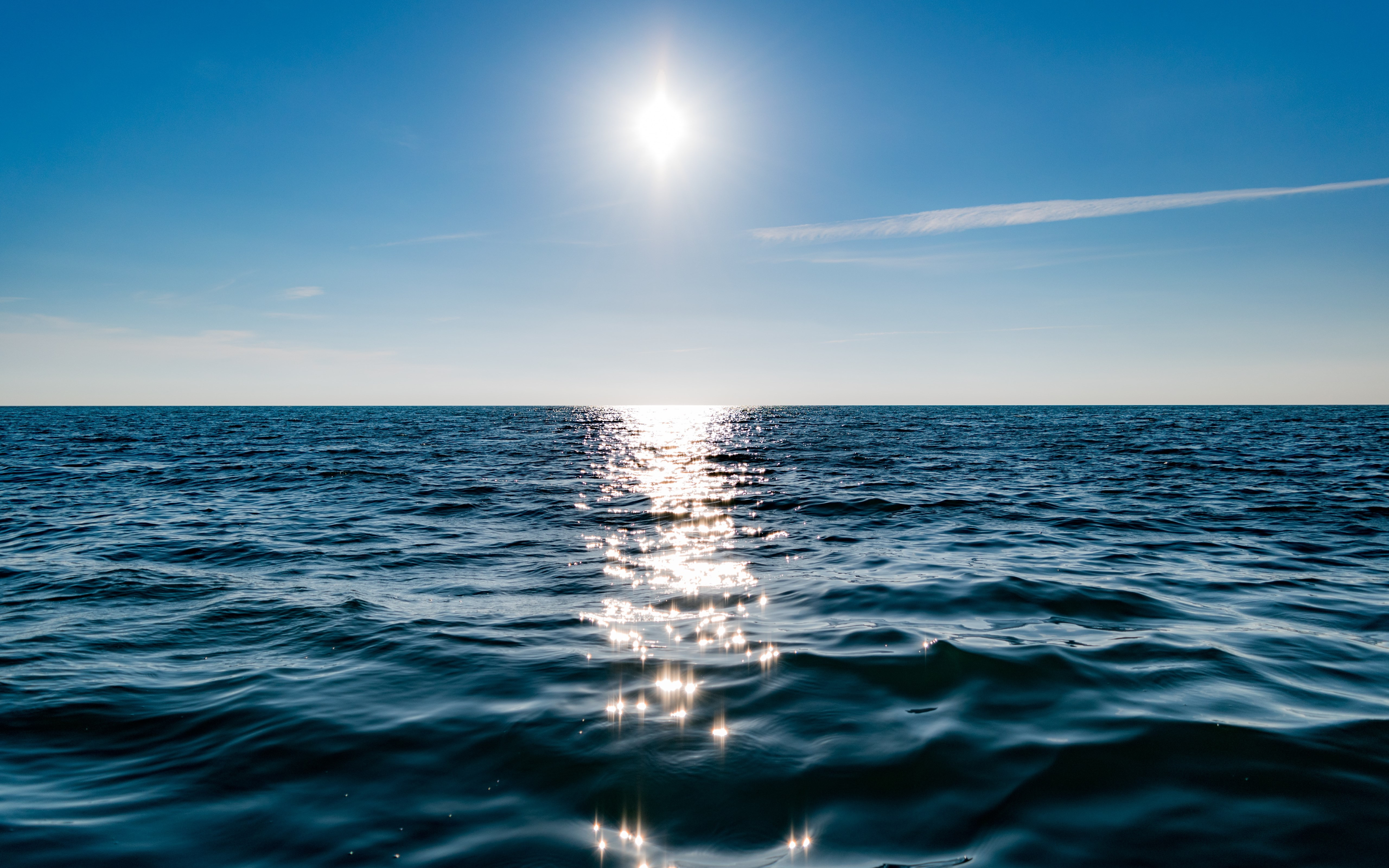 Sun on blue sky is reflected on water wallpaper 5120x3200