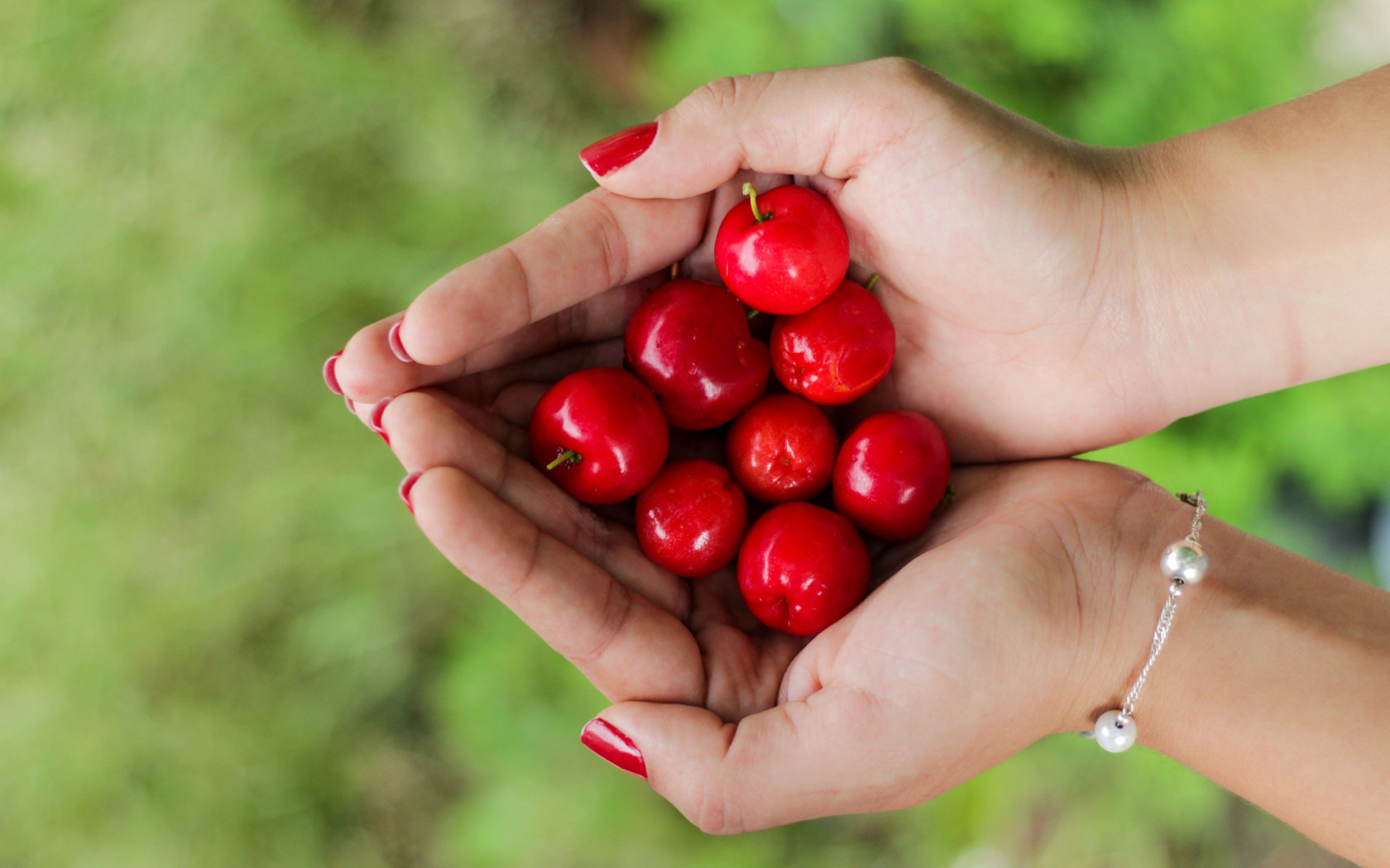 Hands filled with cherries wallpaper 1680x1050