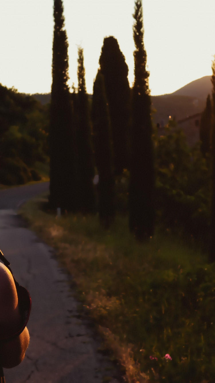 Girl taking pictures at sunset wallpaper 750x1334