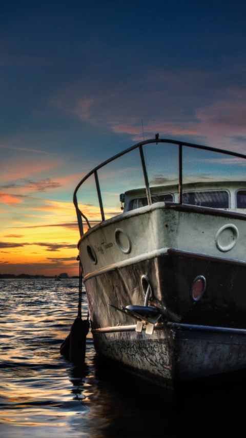Boat and sunset in background wallpaper 480x854
