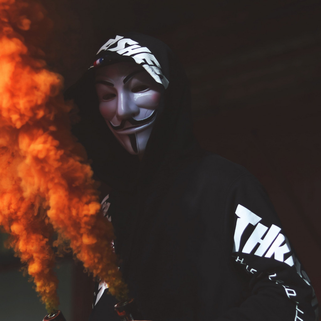 Anonymous mask and orange smoke wallpaper 1024x1024
