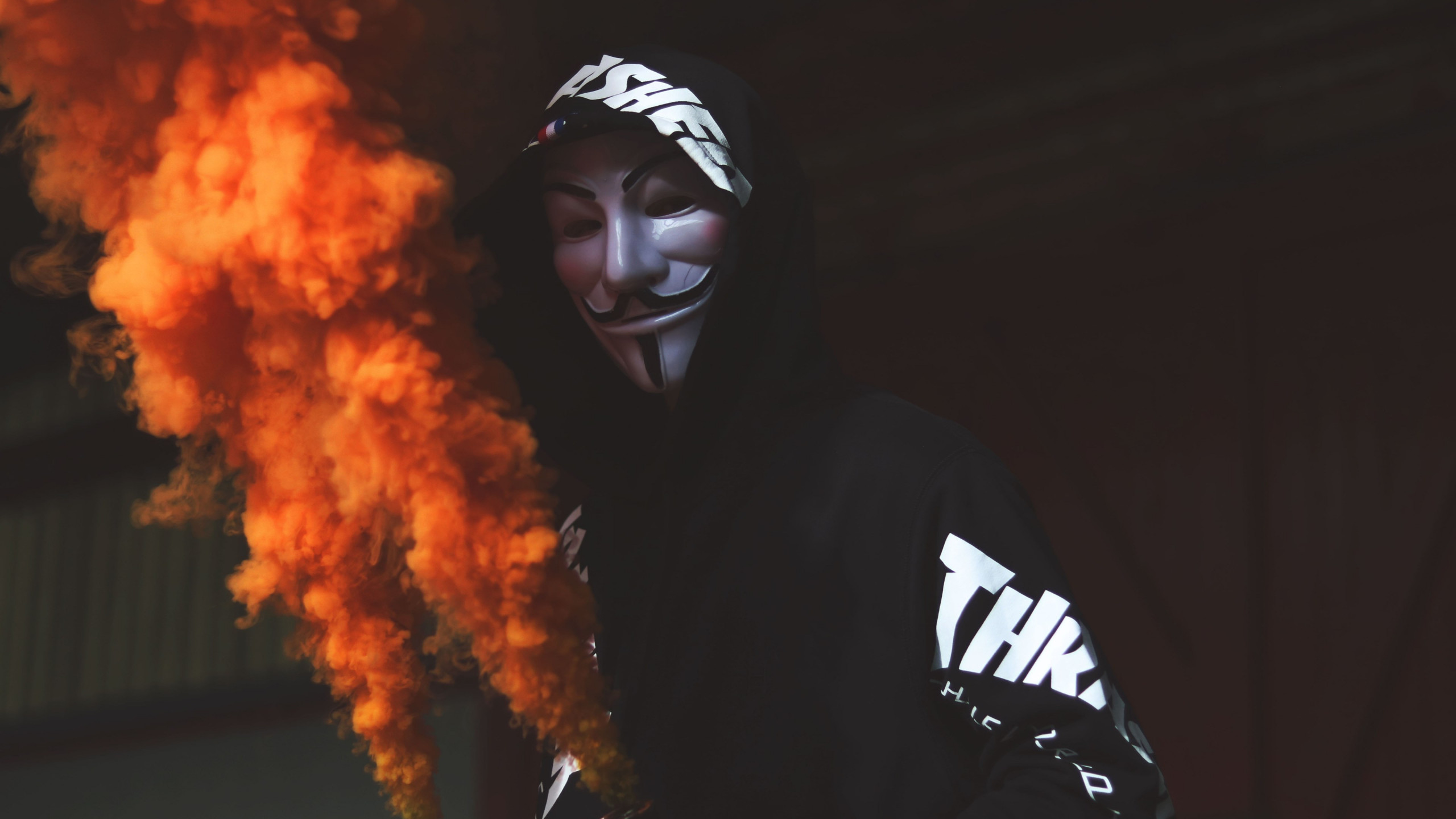 Anonymous mask and orange smoke wallpaper 2560x1440