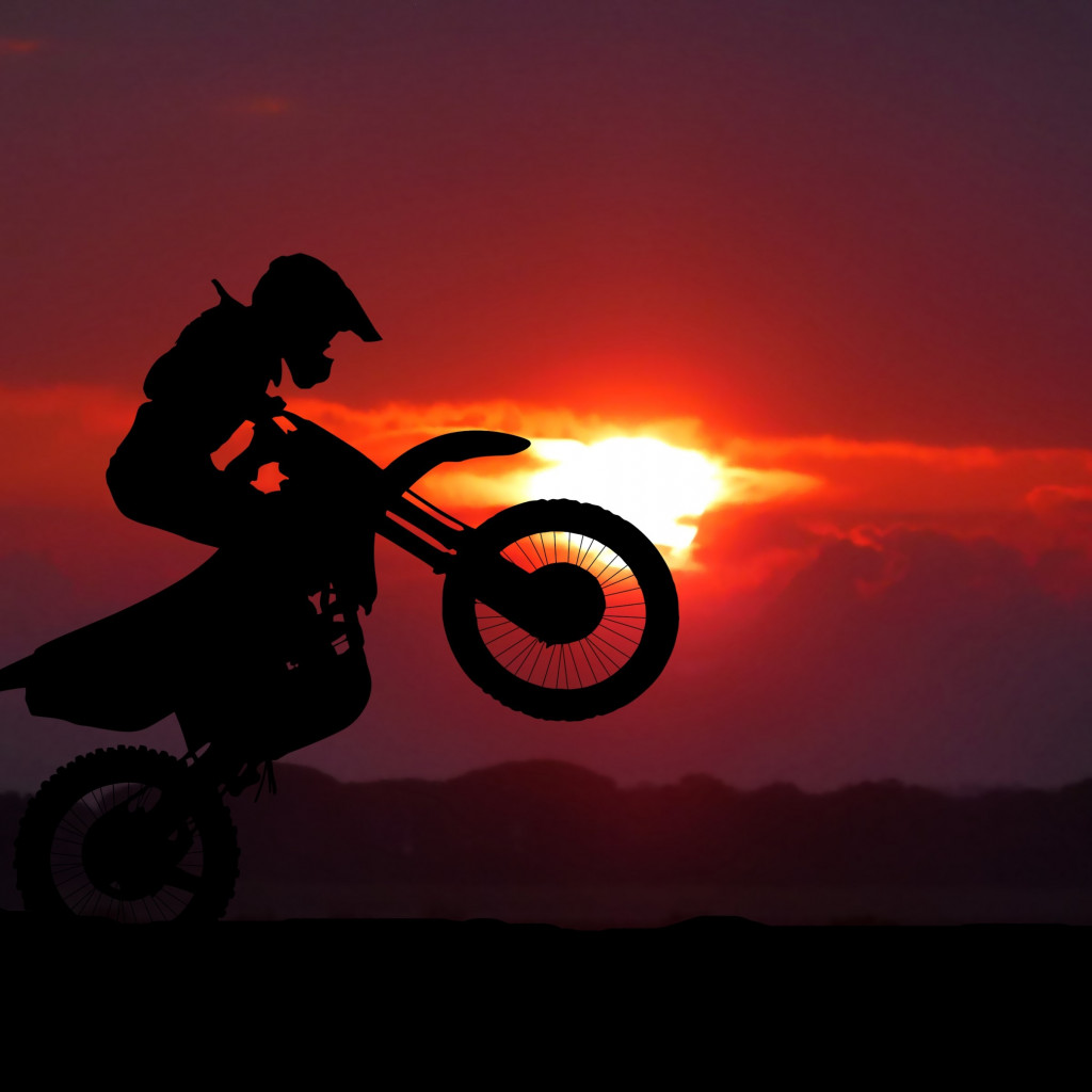 Biker on motorcycle at sunrise wallpaper 1024x1024