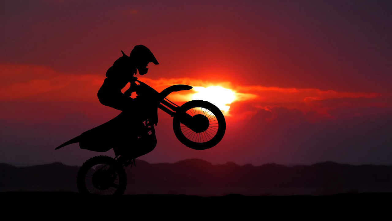 Biker on motorcycle at sunrise wallpaper 1280x720
