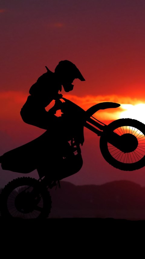 Biker on motorcycle at sunrise wallpaper 480x854