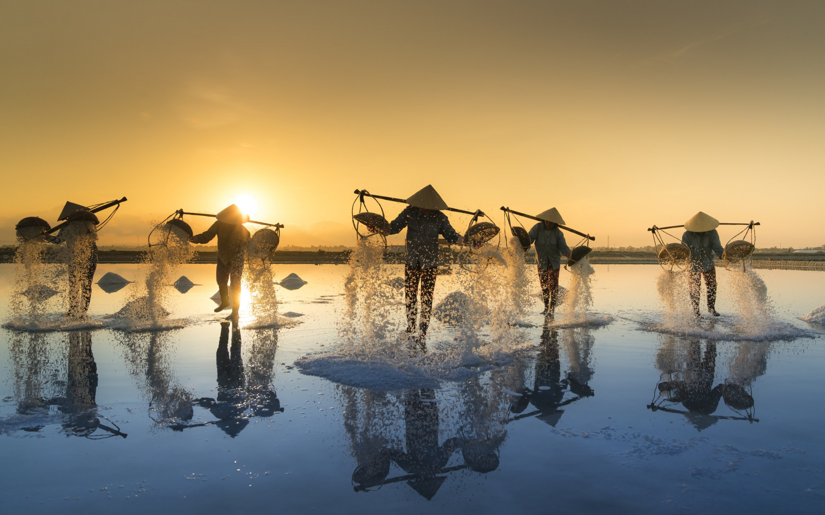 People harvesting salt in Vietnam wallpaper 1680x1050