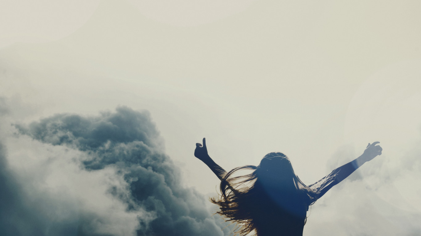 Girl silhouette above clouds wallpaper 1366x768