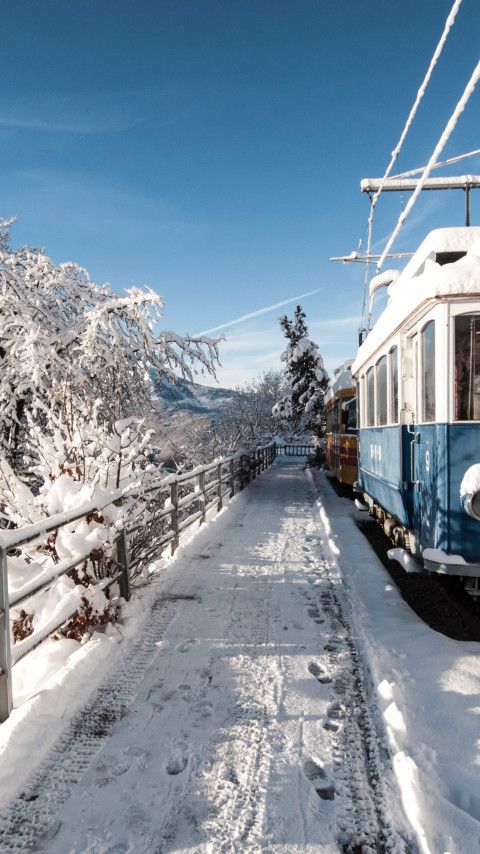 Old train covered with snow wallpaper 480x854