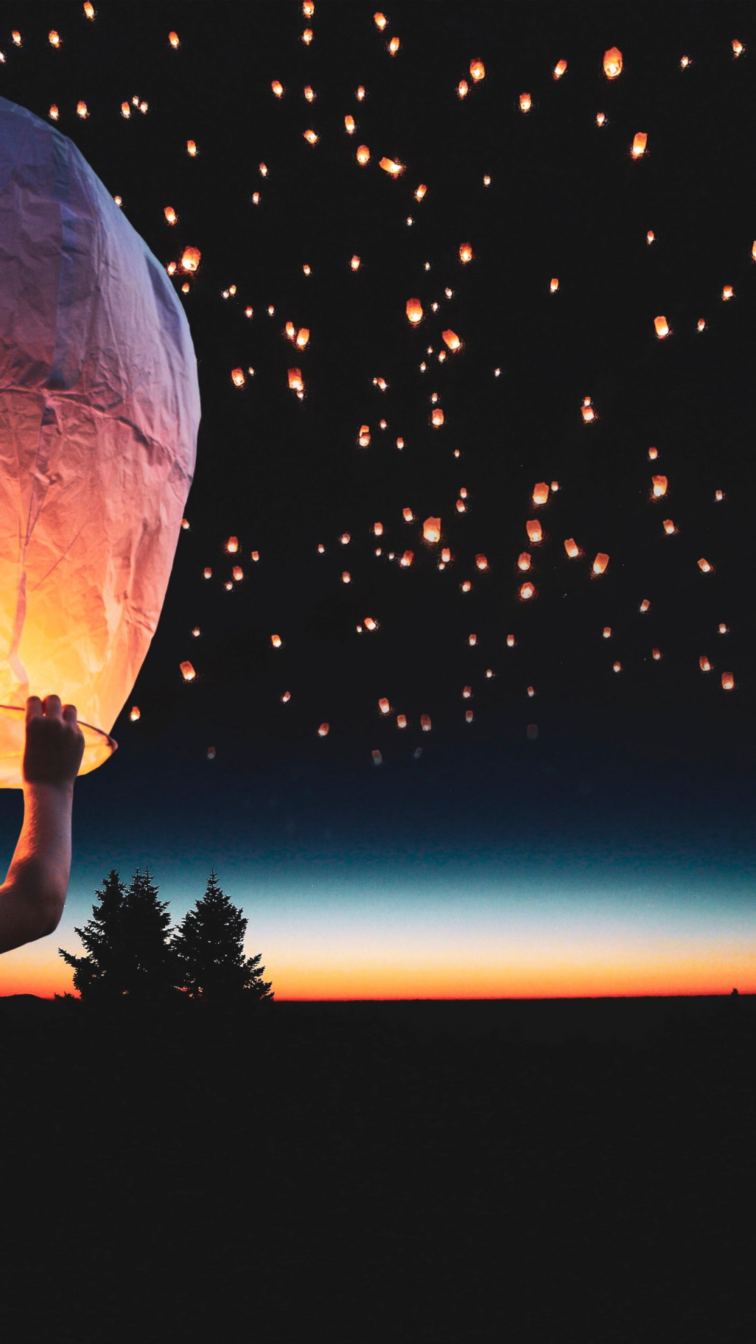 Download wallpaper: Lanterns floating on the night sky 1080x1920